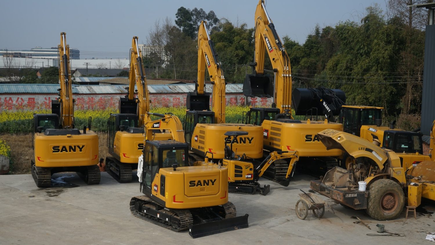 a group of yellow construction vehicles parked next to each other